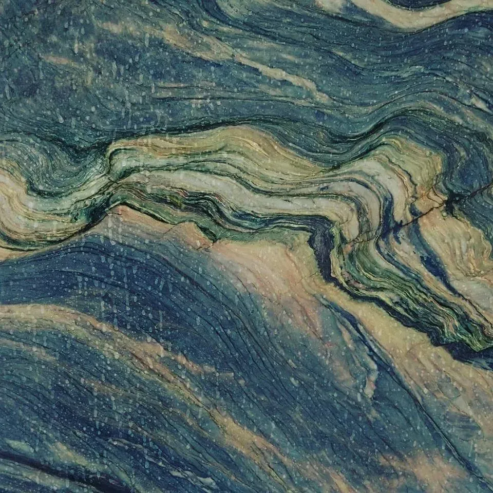 Blue, green, and tan marbled stone with flowing, wavy patterns.