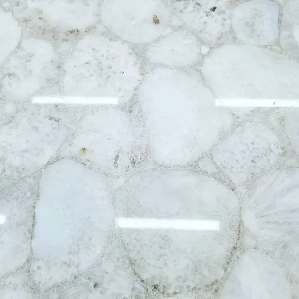 White stone surface with rounded, irregular shapes.