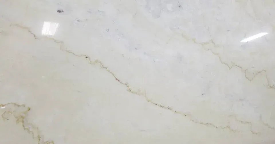Cream-colored marble with beige veining and light reflections.