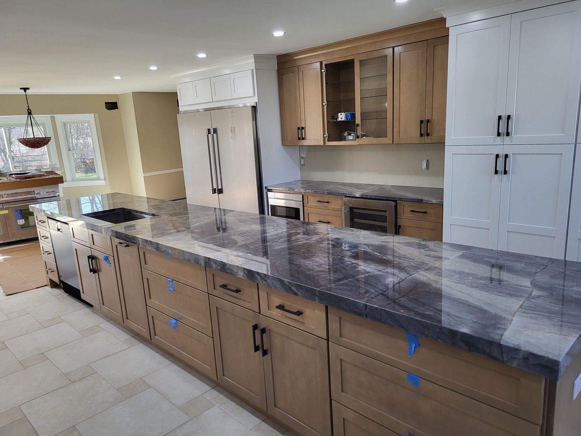 Kitchen with light brown cabinets, dark countertops, and stainless steel appliances.