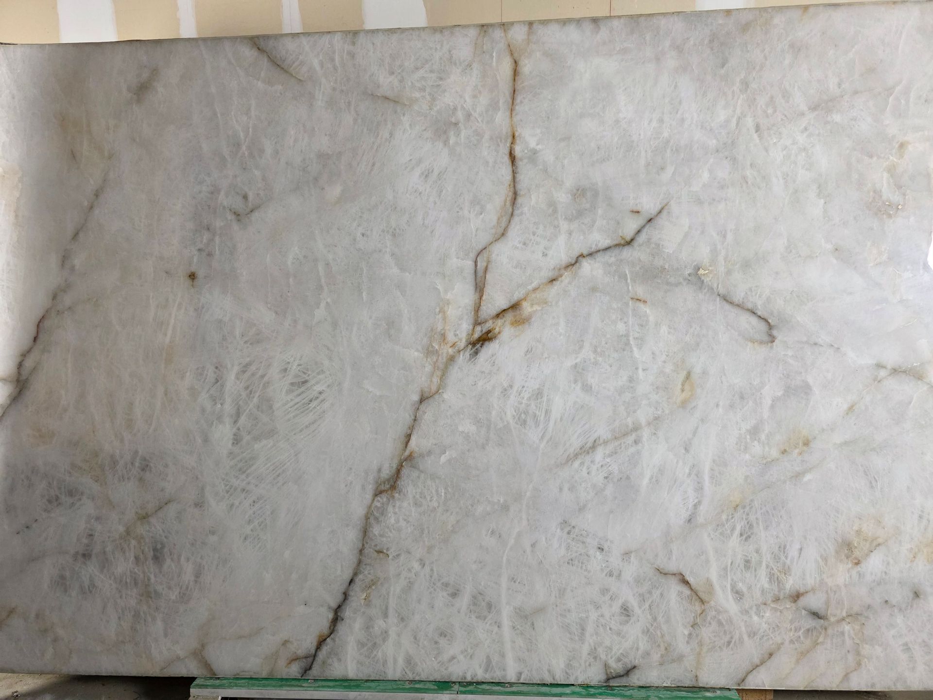 White marble slab with tan veining.