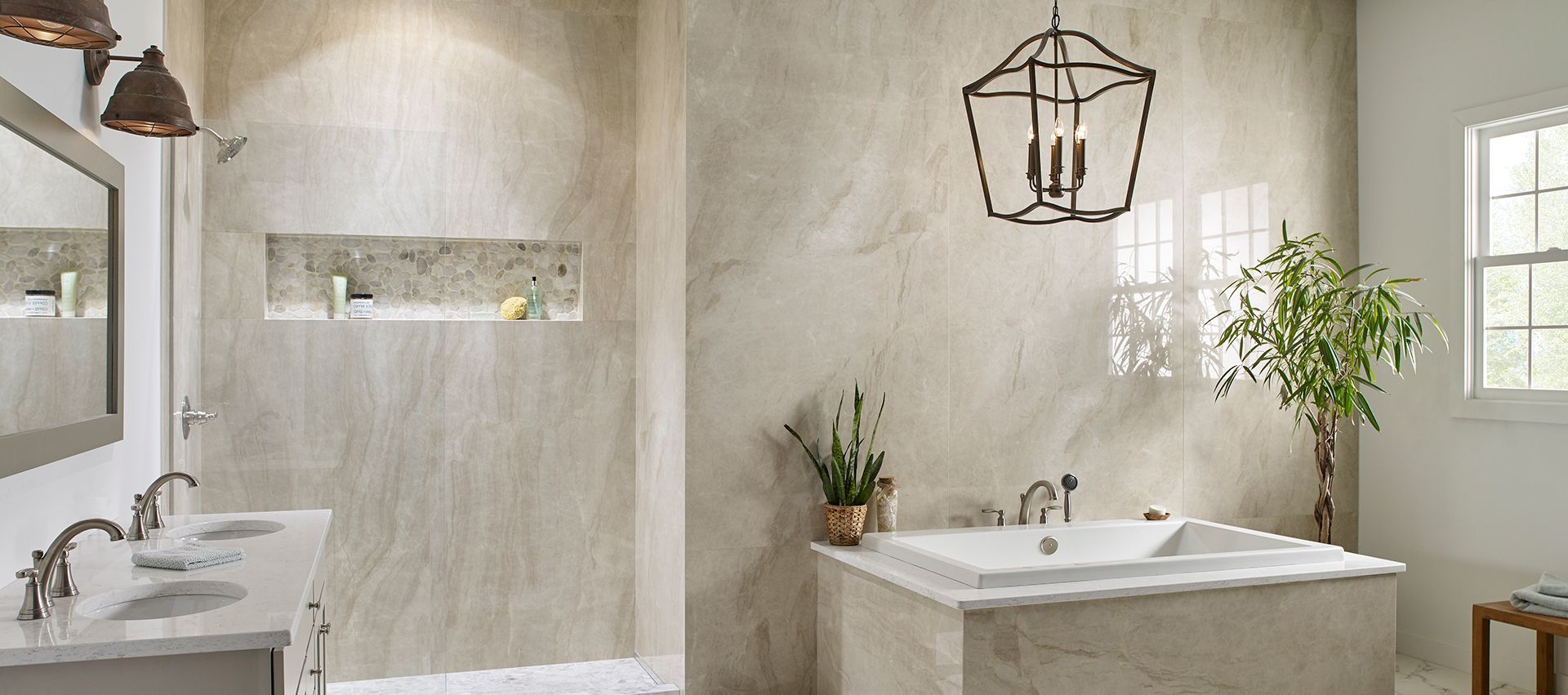 A luxurious bathroom with a tub, shower, and double vanity. Earth-toned walls and a decorative light fixture.