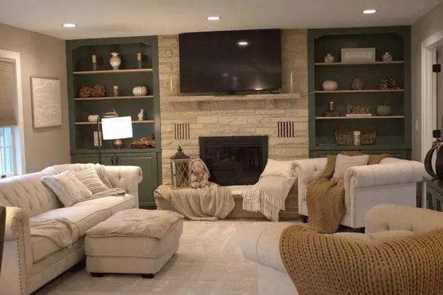 Living room with fireplace, built-in shelves, couches, and neutral decor.
