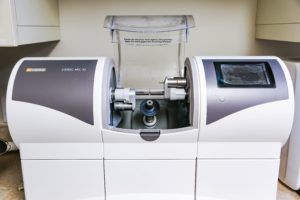 A dental machine is sitting on a counter in a dental office.