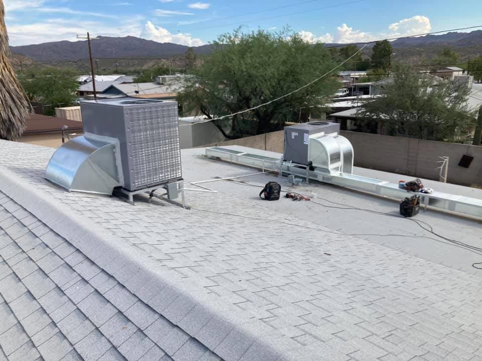 A roof with a lot of air conditioning equipment on it.