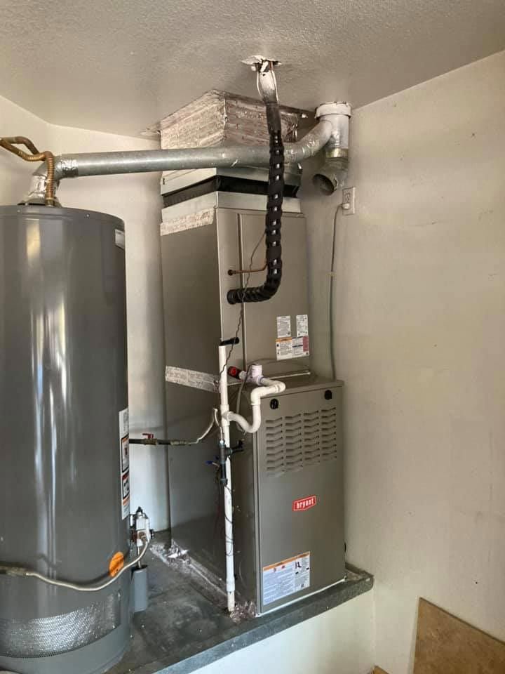 There is a water heater and a furnace in the room.