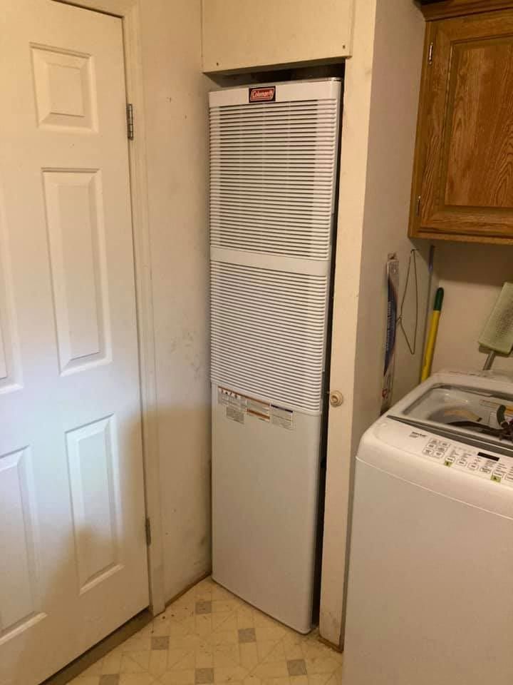 A laundry room with a washer and dryer and a refrigerator.