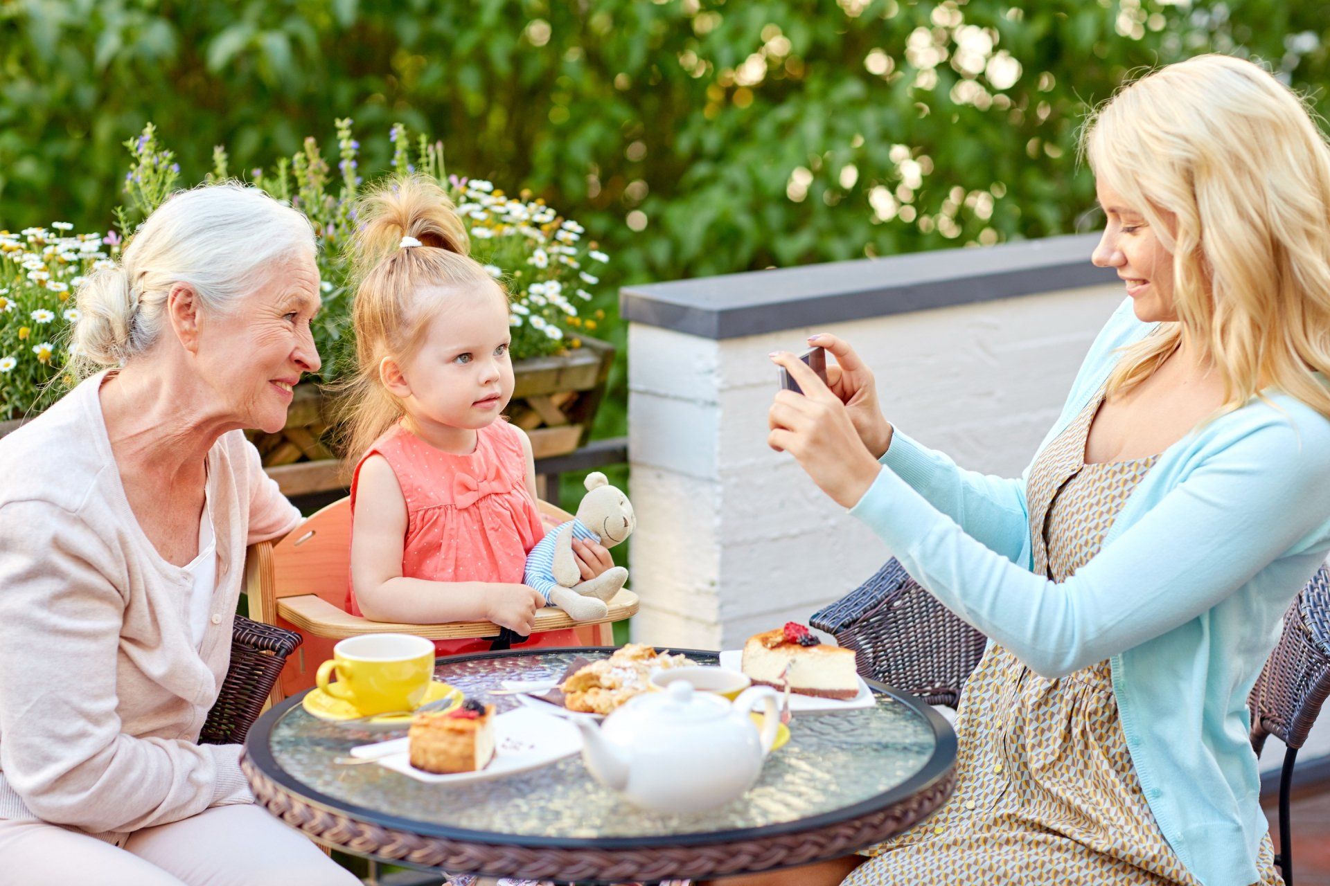 mom and daughter with grandma dining outdoors
