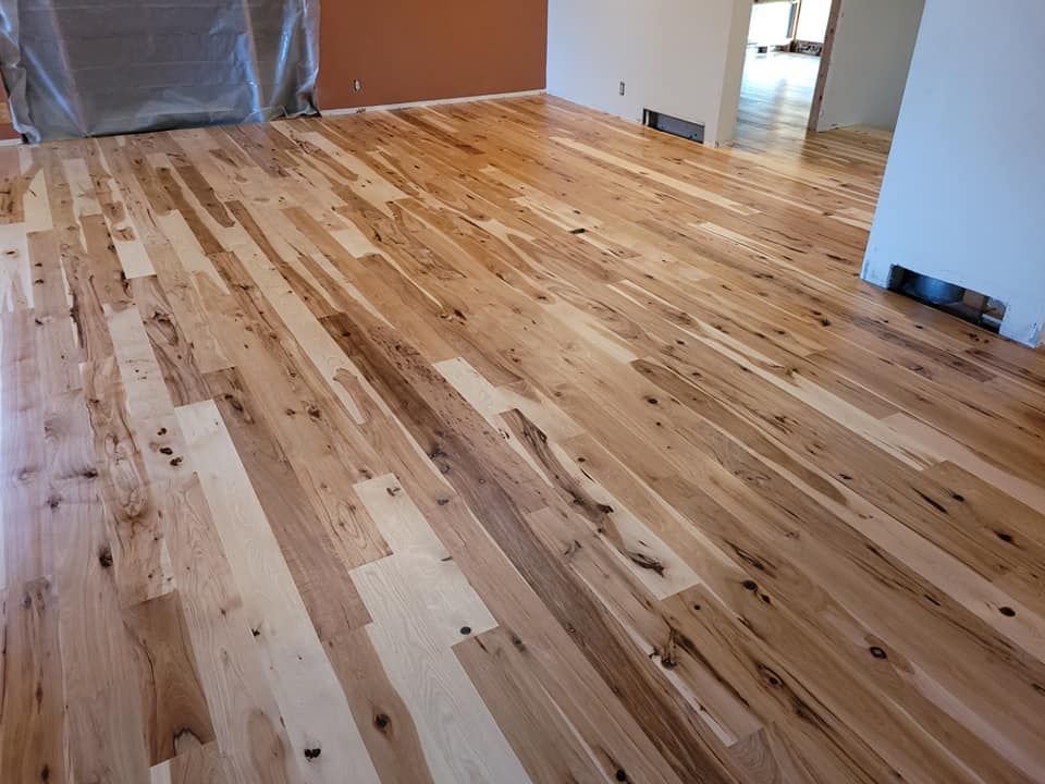 Newly installed hardwood floor with varied light and dark wood tones.