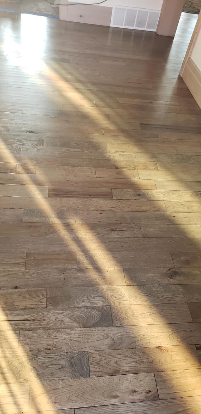 Wooden floor with sunlight streaming across it.