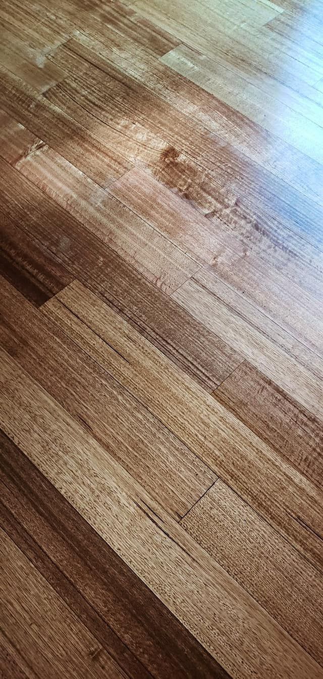 Wooden floorboards with variations in color and grain.