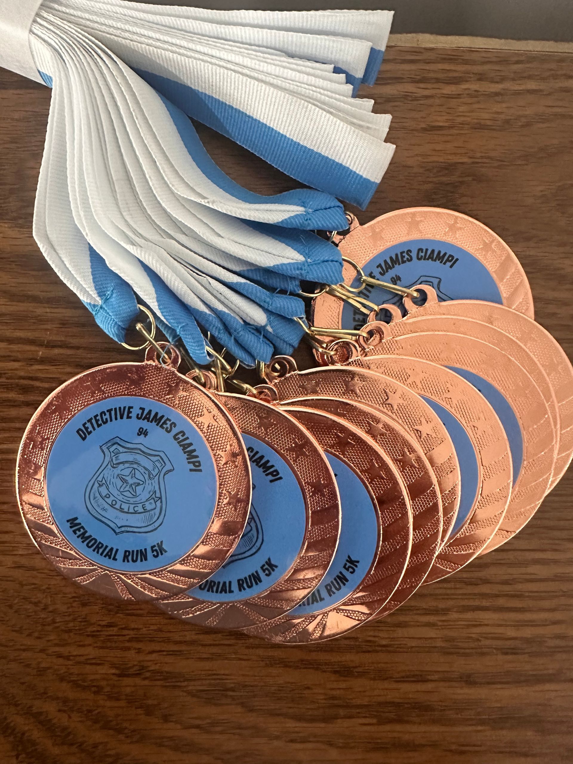 Medals with blue and white ribbons; copper-colored medallions with blue centers and text.