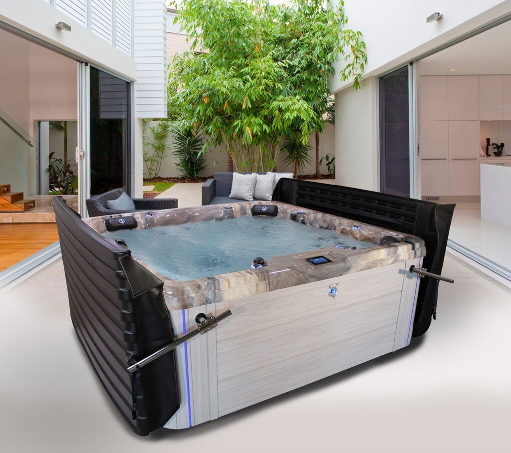 Inflatable hot tub in a modern courtyard with trees and sliding glass doors