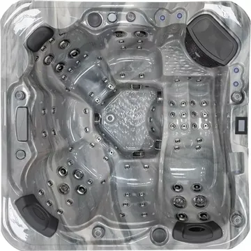 Top-down view of a clear acrylic hot tub with multiple jets, dark headrests, and a central seat area