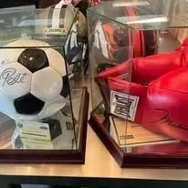 Display cases with a soccer ball and red boxing gloves.