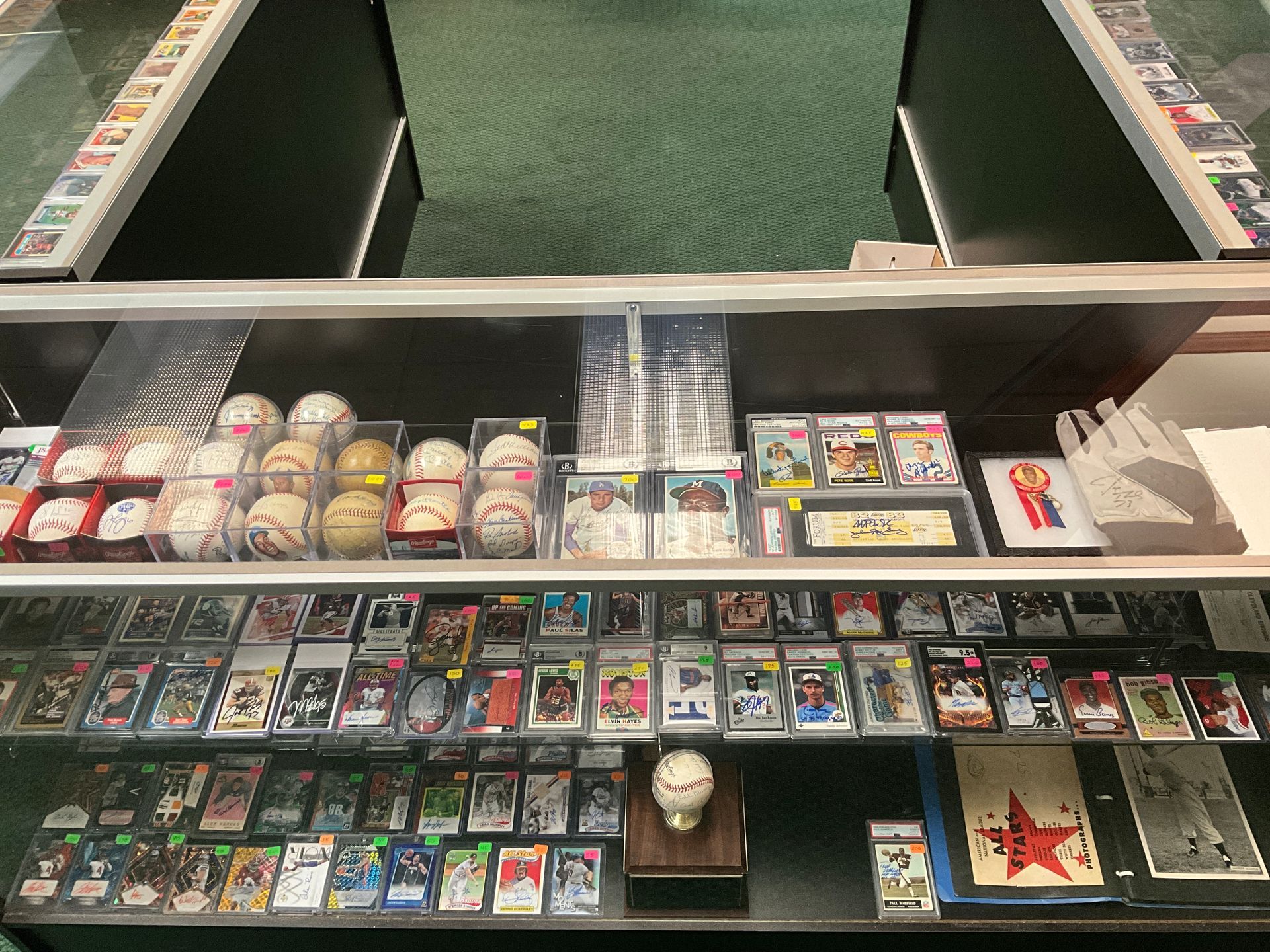 Baseball cards and memorabilia displayed in a glass case.