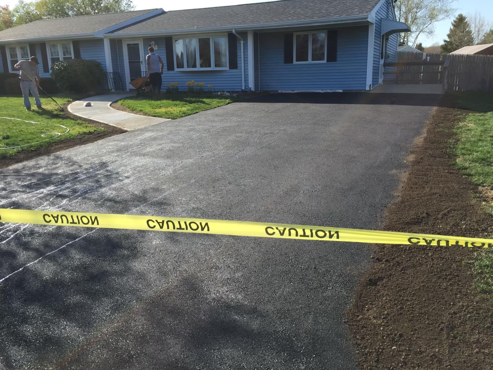 a blue house is behind a yellow caution tape