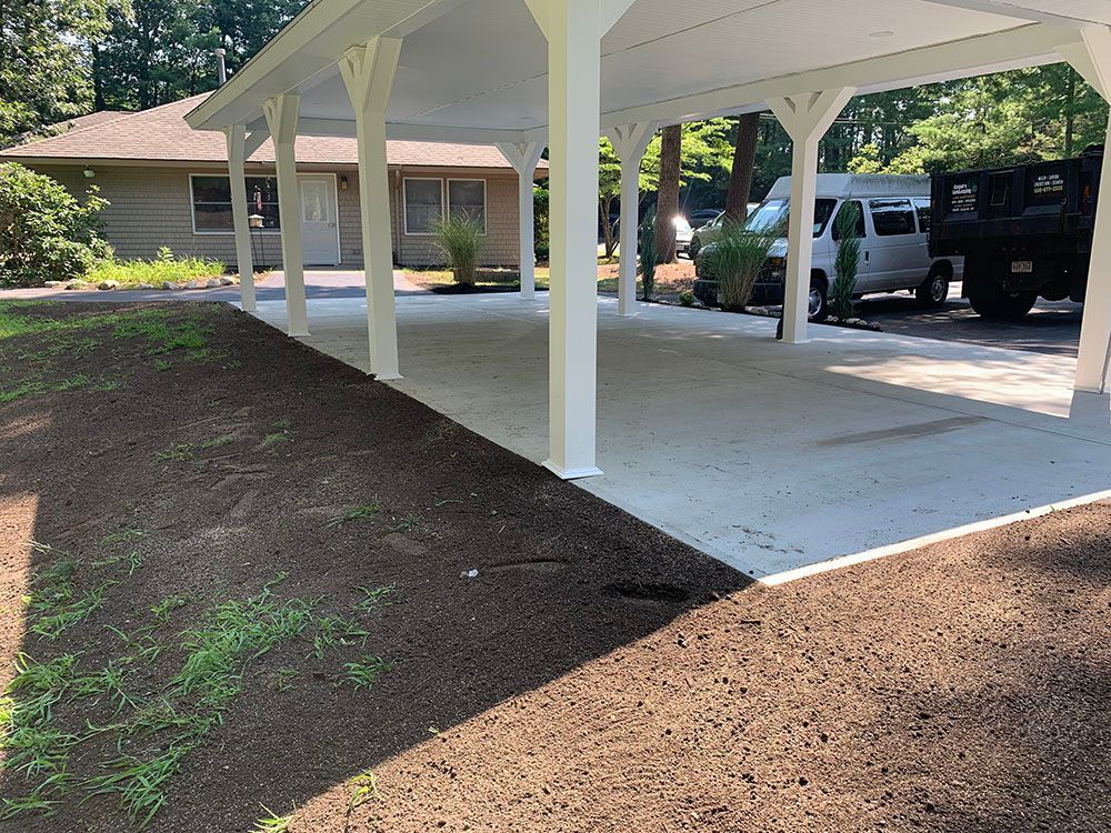 A serene white gazebo stands in the center of a yard.