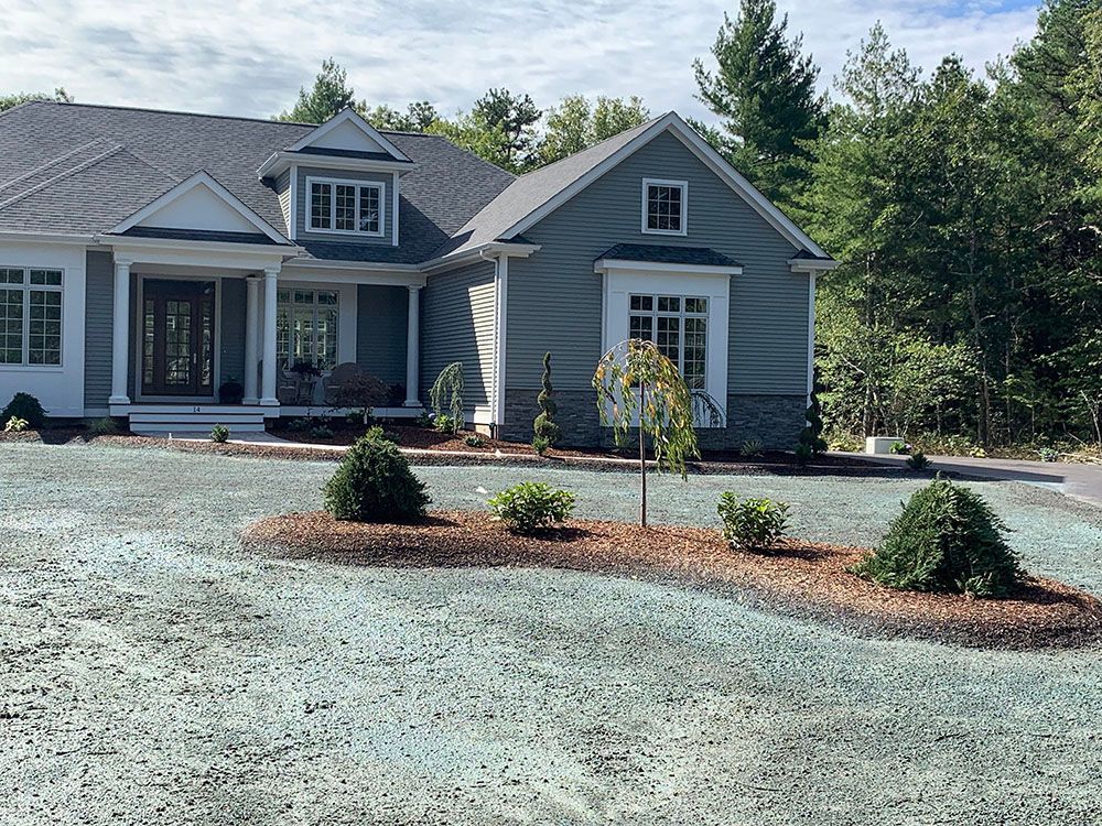 Residential property with driveway and gravel space.
