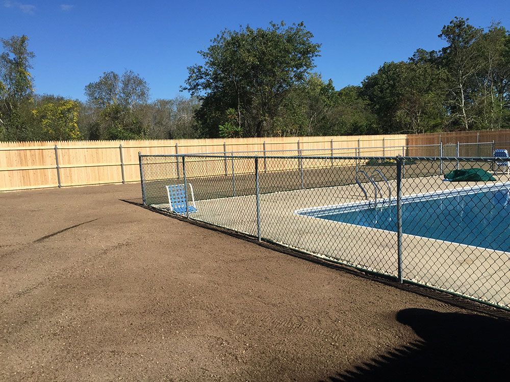 Wooden fence with swimming pool.