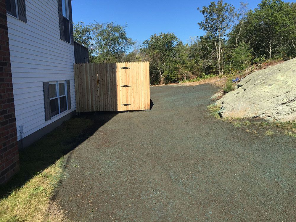 Driveway with wooden fence and gate.
