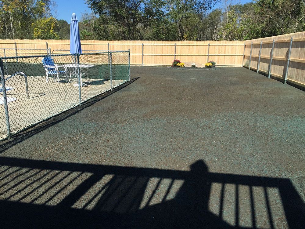 A fenced area with gravel lawn.