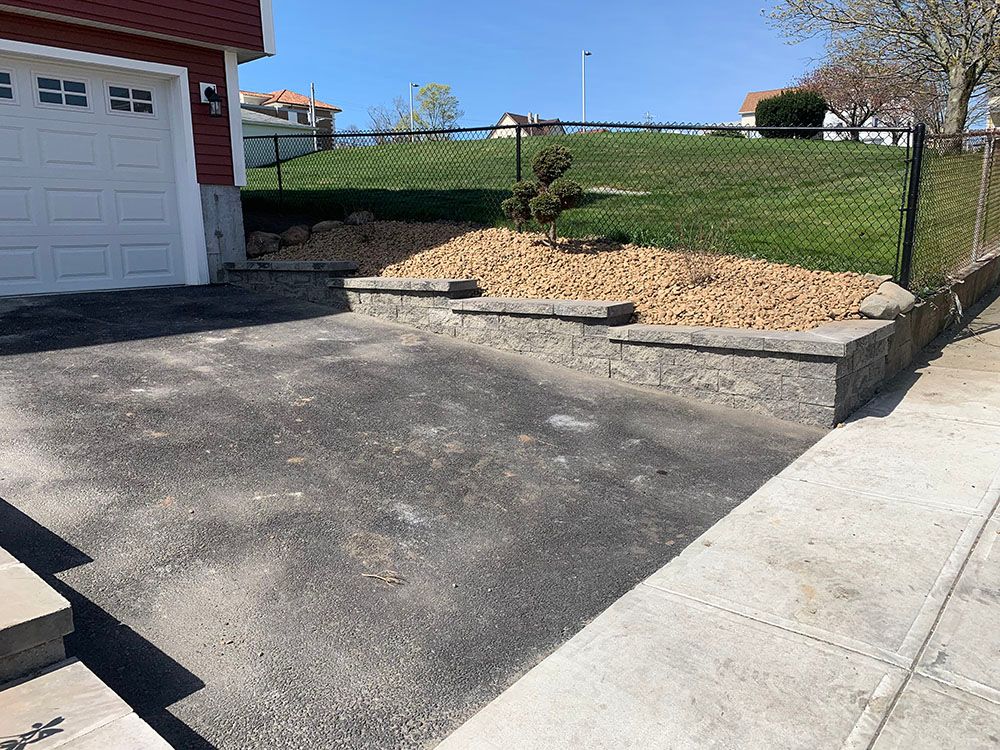 Driveway with concrete steps leading up to a garage.