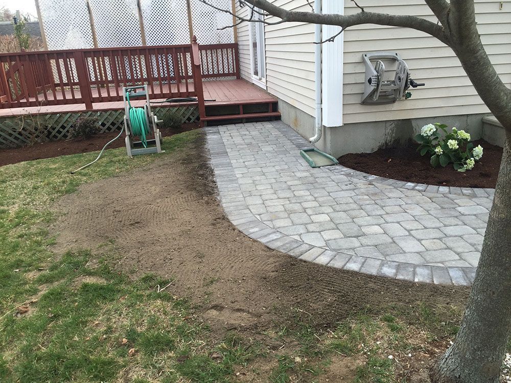 A patio with a brick path.