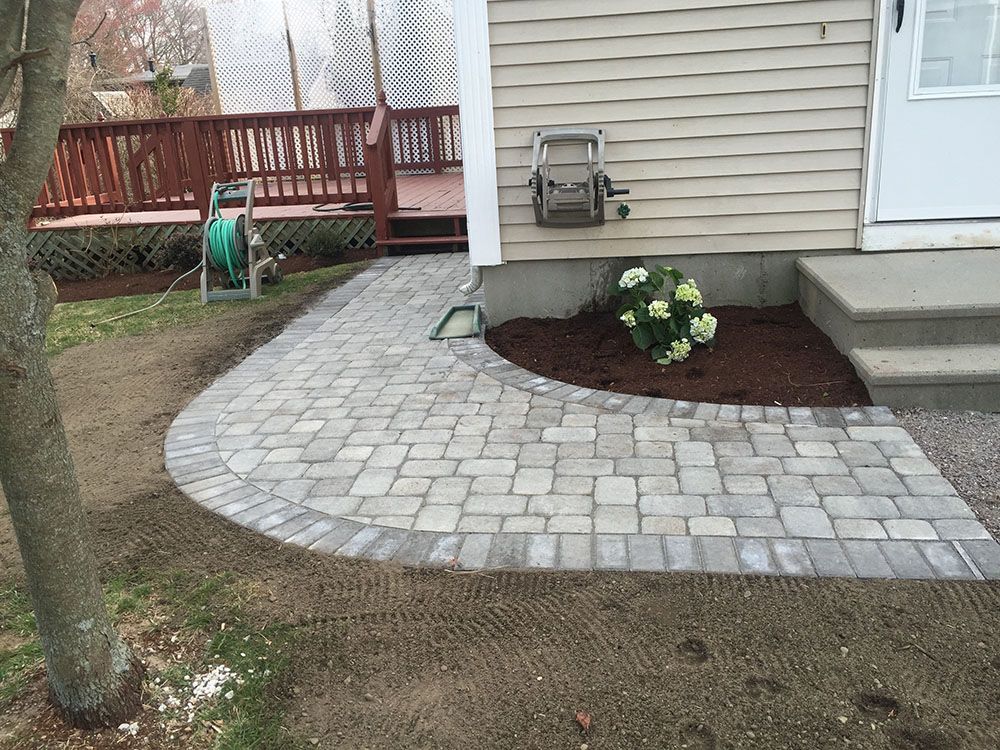 A charming patio with a brick path.