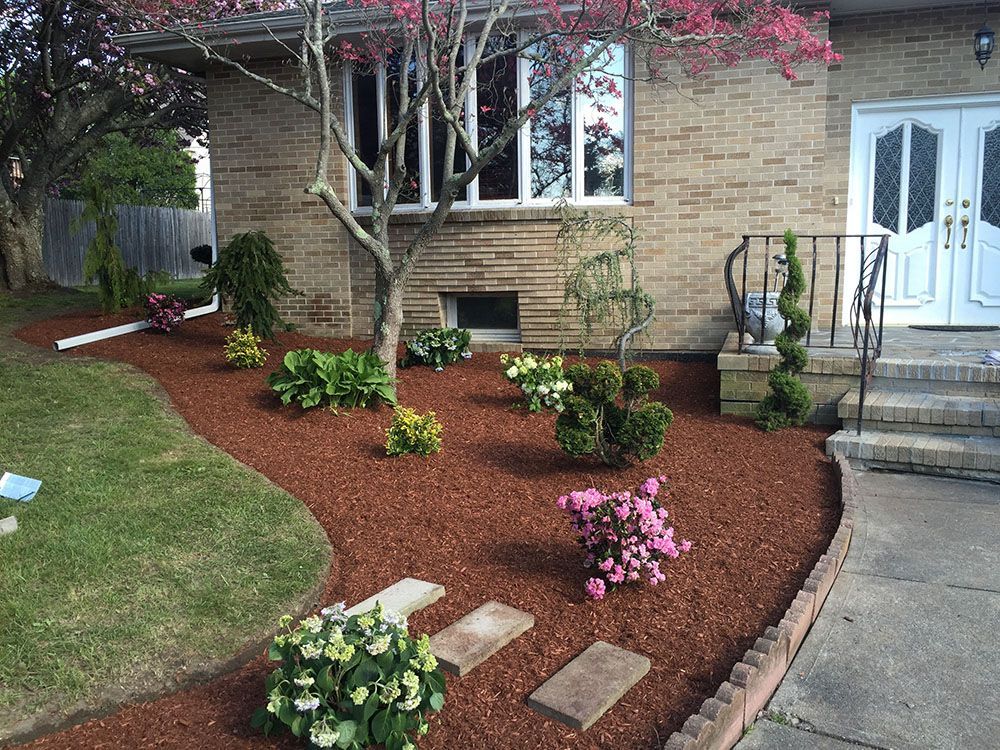 House with white door and a beautiful garden.