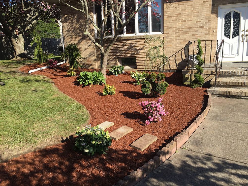 House with mini garden and grass lawn.