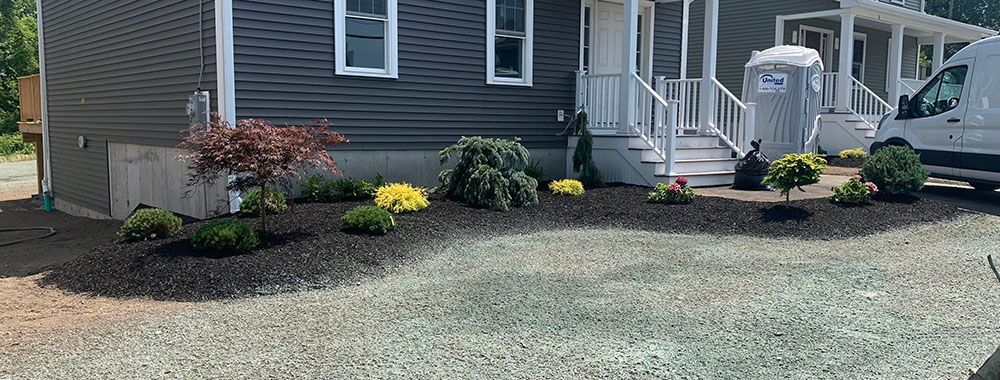 House with lawn gravel and a mini garden.