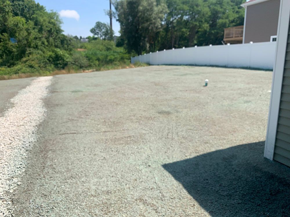 Lawn gravel with white fence.