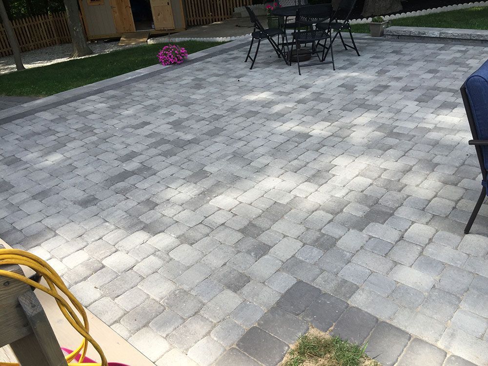 Concrete floor with table and chairs.