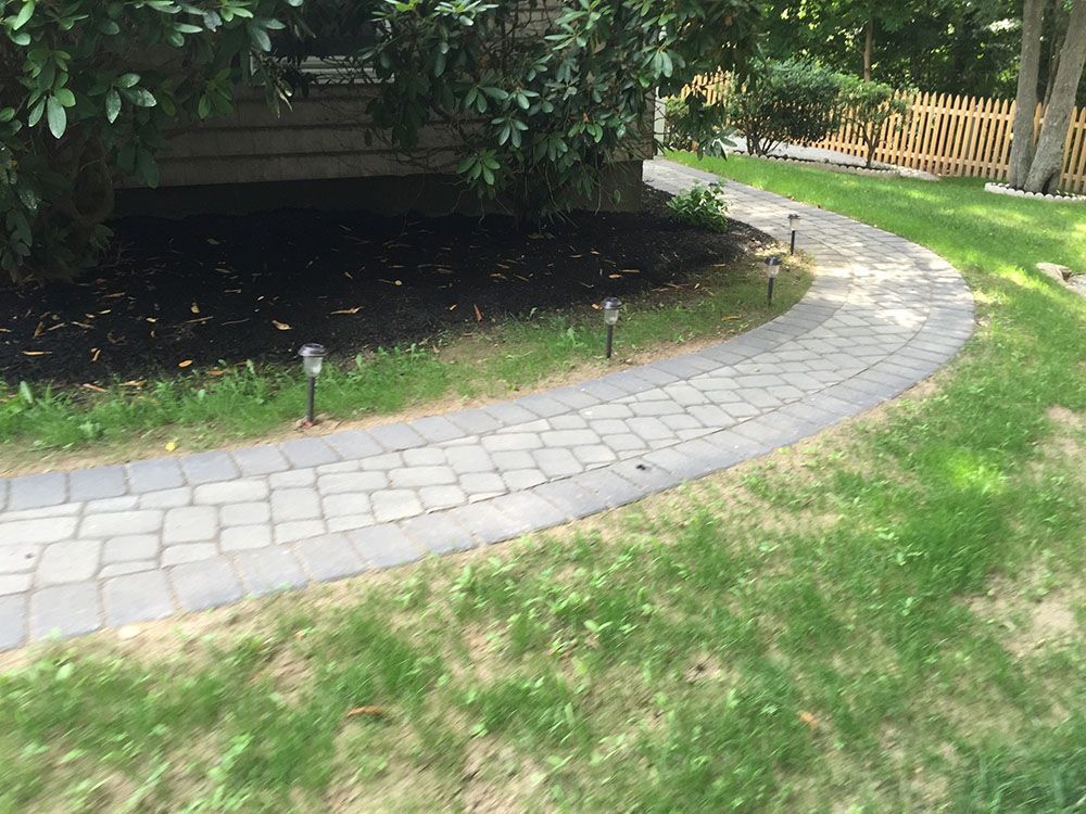 Concrete pathway with green lawn.