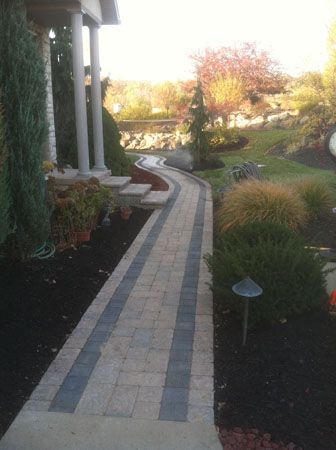 Concrete pathway and a garden on both side.