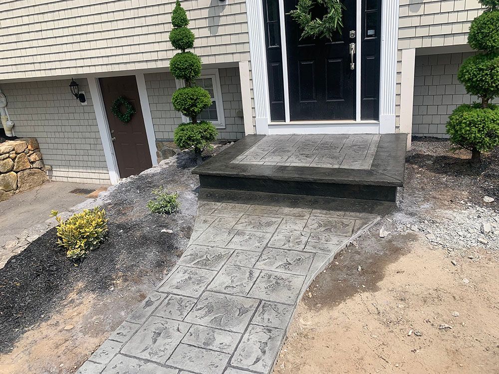 Front door with concrete walkway.