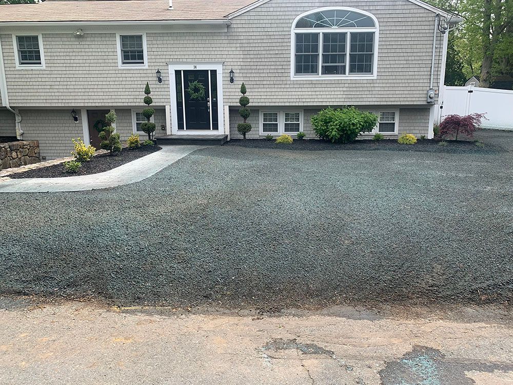 House with gravel driveway.