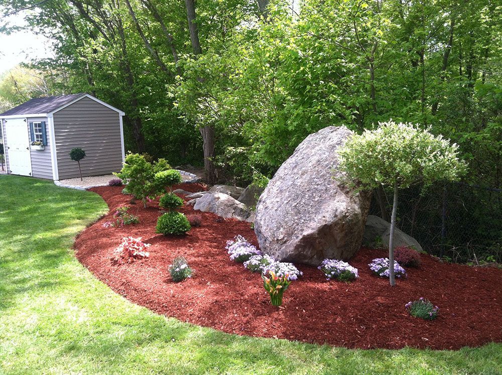 Image of a solitary rock on a grassy field.