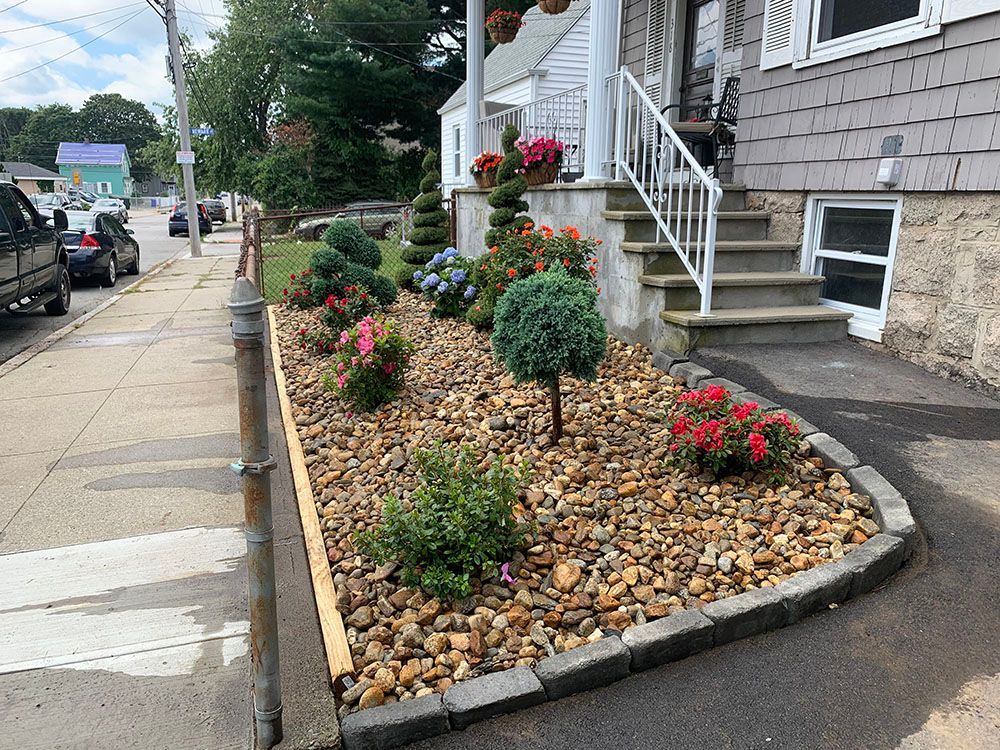 A colorful flower bed enhances the beauty of a house, adding vibrancy and charm to the surroundings.