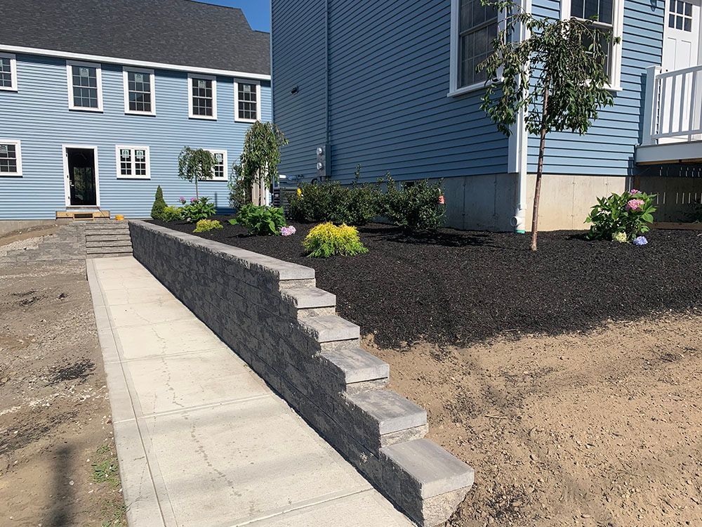 A house with a retaining wall in the foreground.