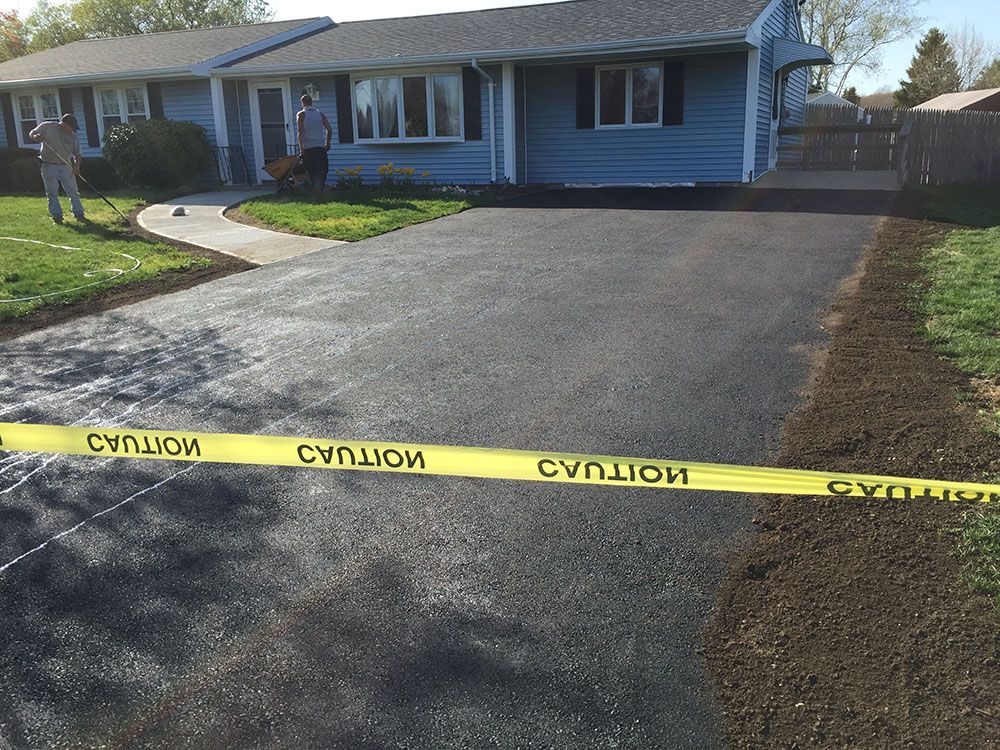 A newly paved asphalt driveway.