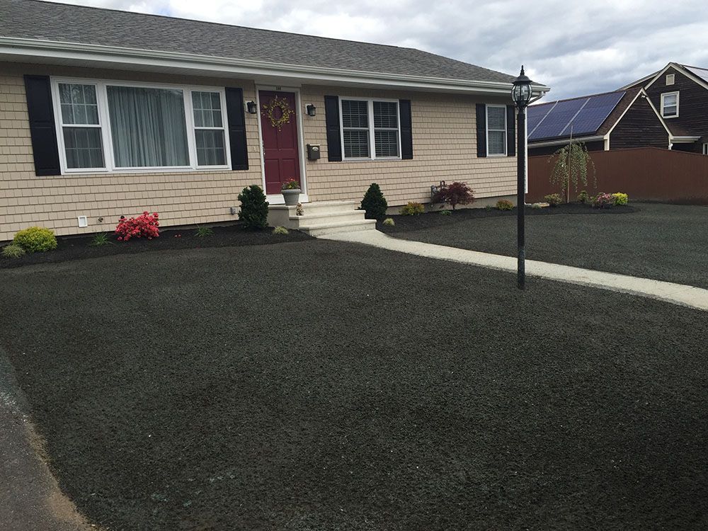 Black mulch bed and landscaping in driveway.