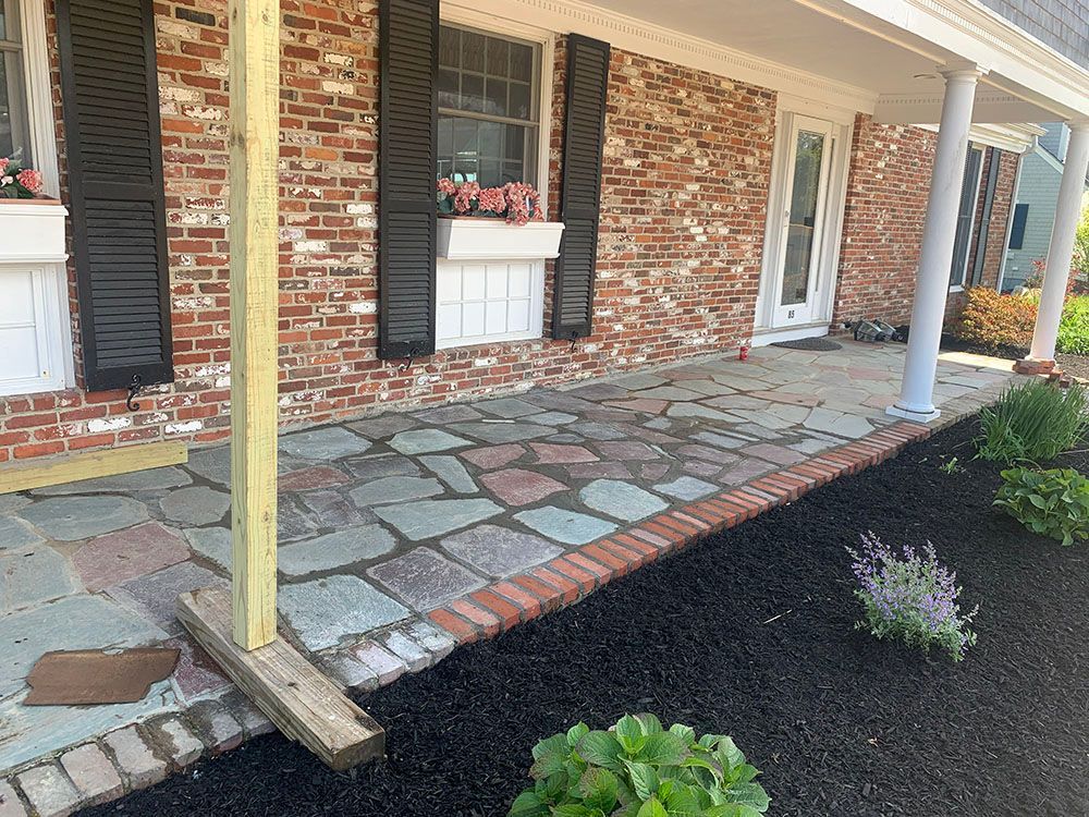 A stone walkway lined with a brick.