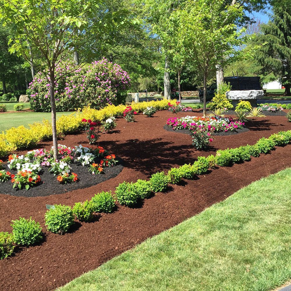 A beautiful landscaping design featuring a colorful flower beds.