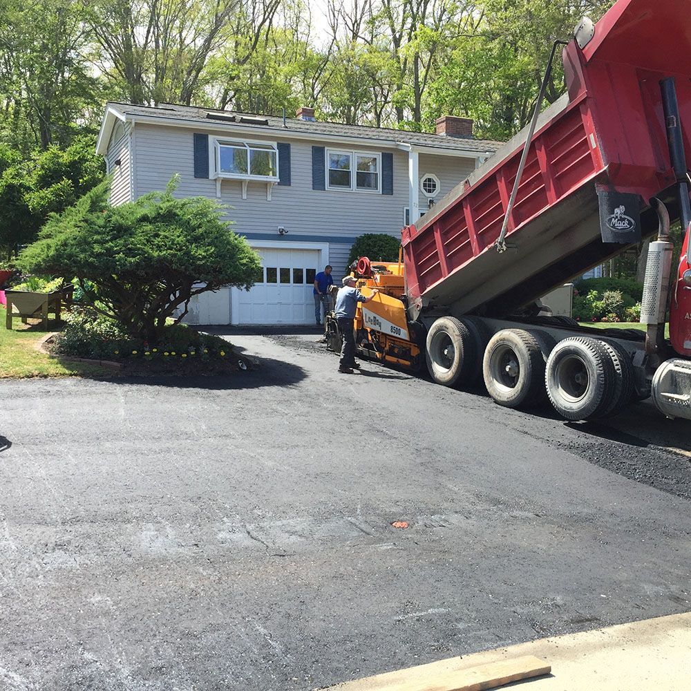 A construction vehicle parked in a driveway.