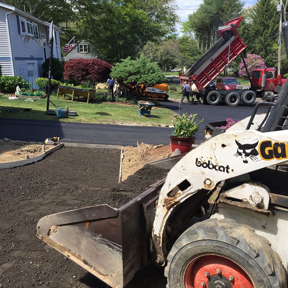 Image of a construction vehicle parked in a driveway.