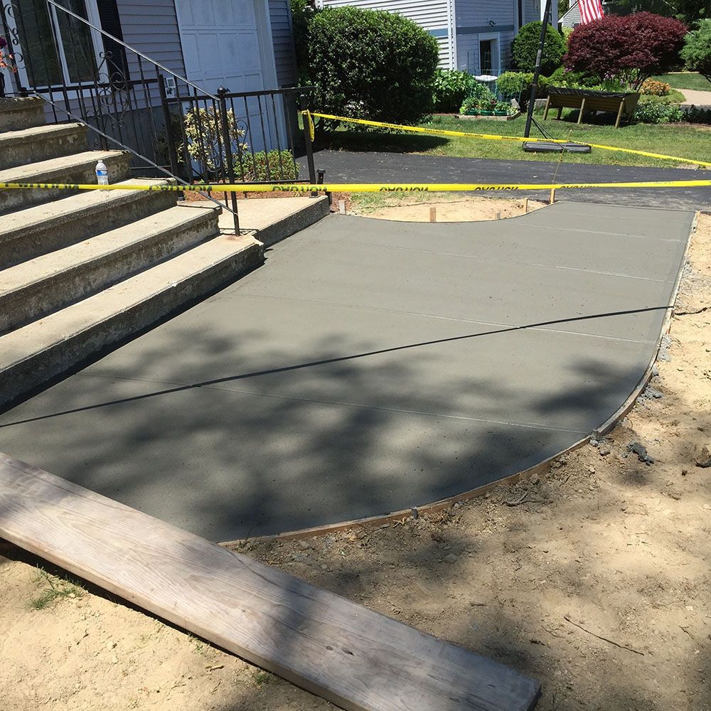 Newly poured concrete patio in residential area.