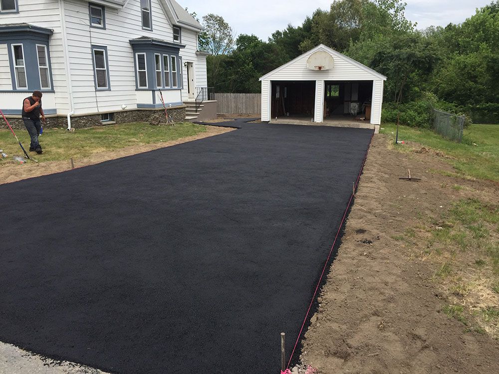 A black asphalt driveway leading to the garage.