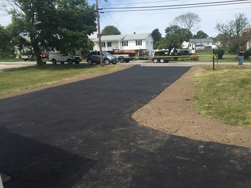 A black asphalt driveway leading to the street.
